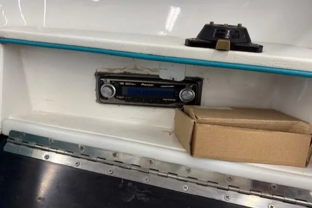 Slide: The Image of 1991 Larson All American 170 boat dashboard with Pioneer stereo and cardboard box. - 11