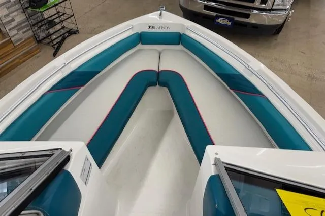 Slide: The Image of 1991 Larson All American 170 boat interior with teal and white seating. - 12