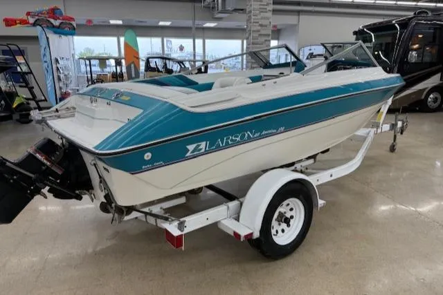 Slide: The Image of 1991 Larson All American 170 boat on trailer in showroom. - 2