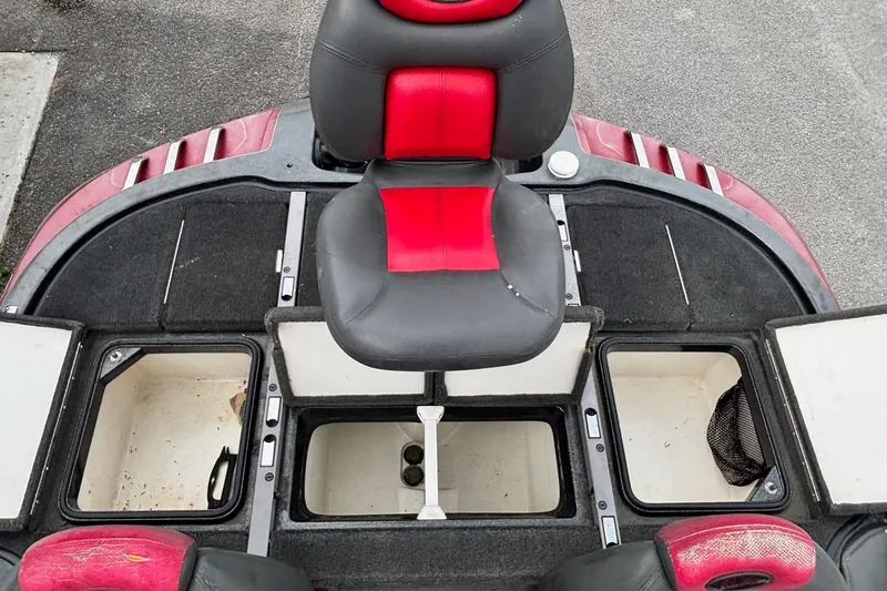 Slide: The Image of 2006 Ranger Z19 Comanche boat interior with storage compartments and red-black seating. - 10