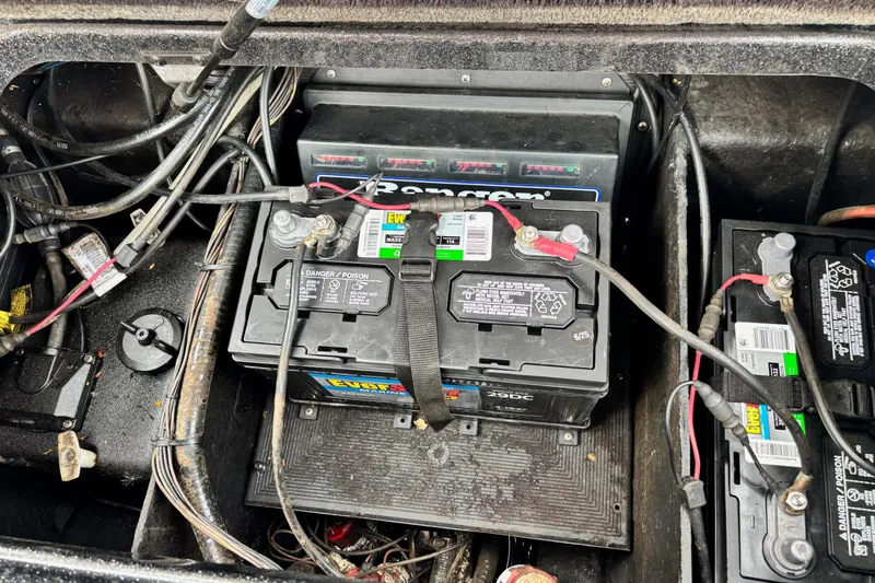 Slide: The Image of Battery compartment of a 2006 Ranger Z19 Comanche boat with wiring and connections. - 12