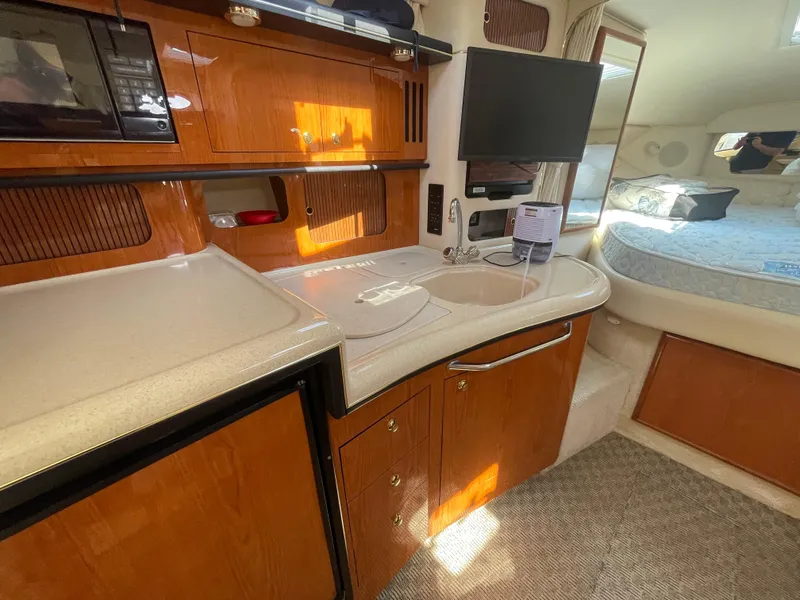 Slide: The Image of Interior of 2001 Sea Ray 340 Sundancer yacht with kitchenette and bed. - 15