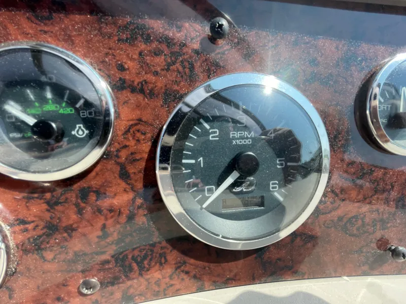Slide: The Image of Close-up of 2001 Sea Ray 340 Sundancer dashboard gauges, featuring RPM and temperature indicators. - 18