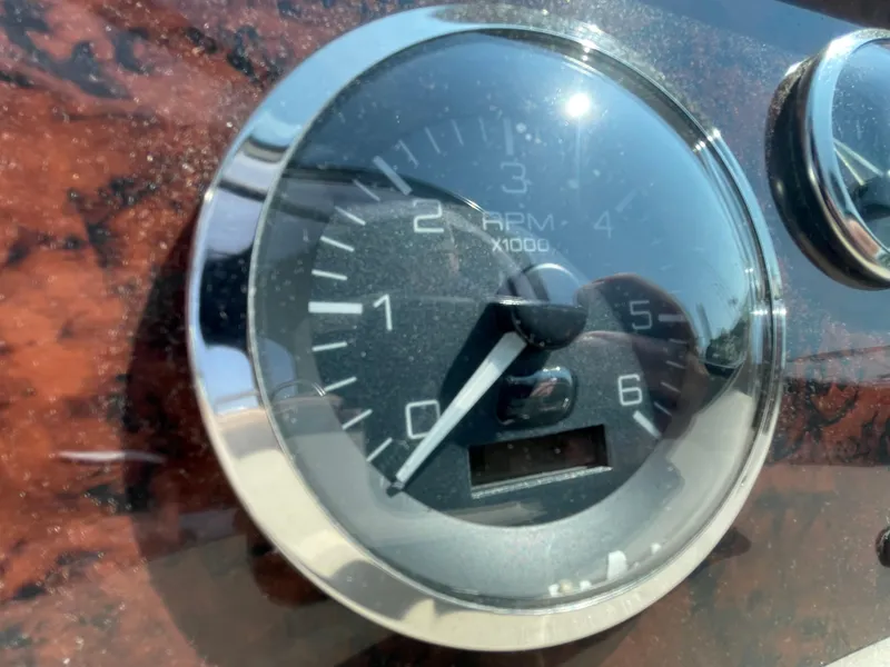 Slide: The Image of Close-up of a 2001 Sea Ray 340 Sundancer RPM gauge on a wooden dashboard. - 19