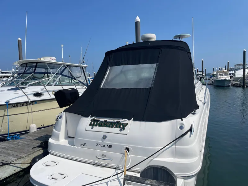 Slide: The Image of 2001 Sea Ray 340 Sundancer docked at marina, rear view with black cover. - 3
