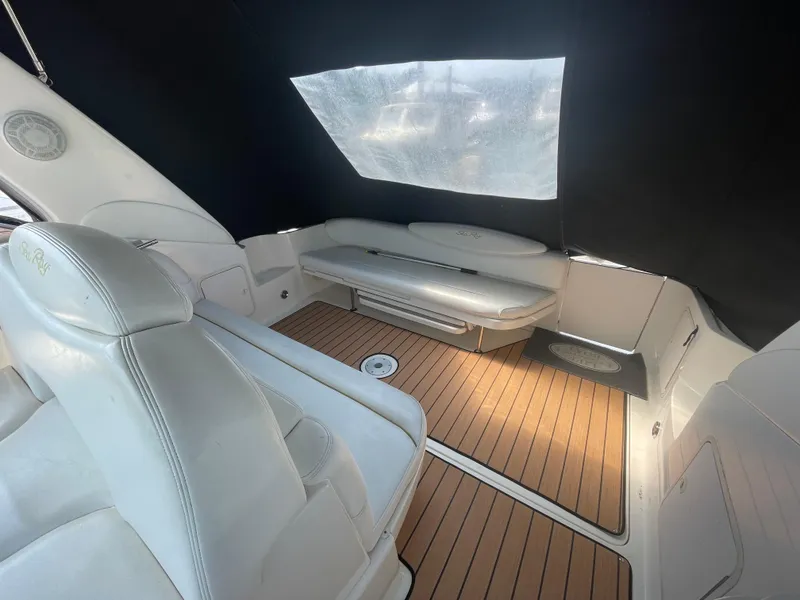 Slide: The Image of Interior of 2001 Sea Ray 340 Sundancer with white seating and wood flooring. - 4