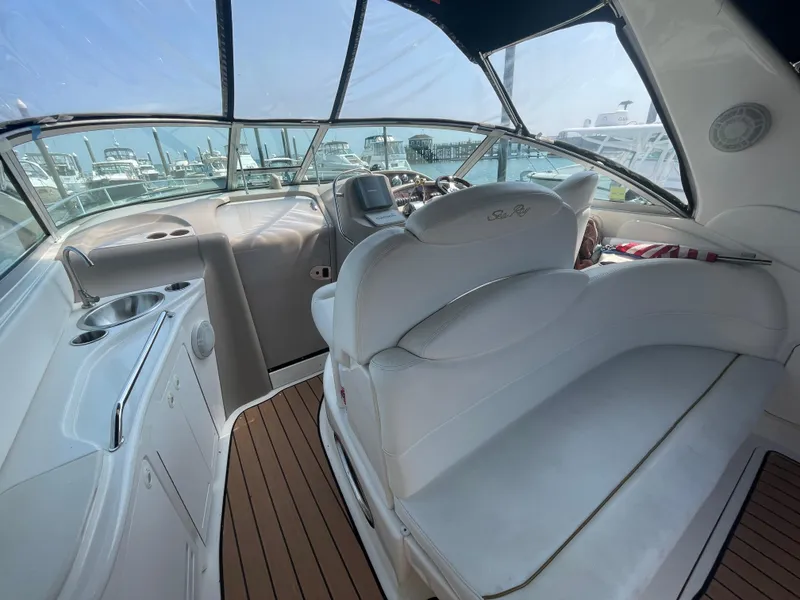 Slide: The Image of Interior of 2001 Sea Ray 340 Sundancer yacht with white seating and wooden flooring. - 5