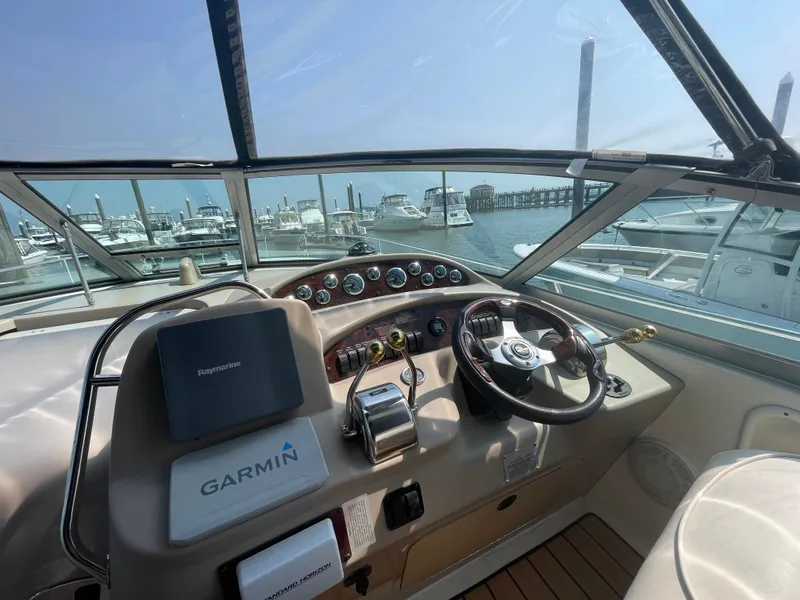 Slide: The Image of 2001 Sea Ray 340 Sundancer helm with Garmin and Raymarine equipment, docked at marina. - 7
