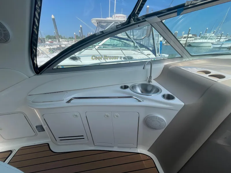 Slide: The Image of 2001 Sea Ray 340 Sundancer cockpit with sink, storage, and marina view. - 9