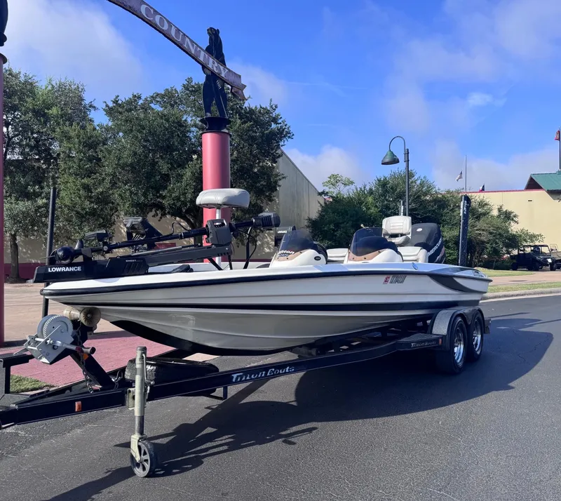 Slide: The Image of 2007 Triton Tr-20X HP DC boat on trailer, parked outdoors under a clear sky. - 1