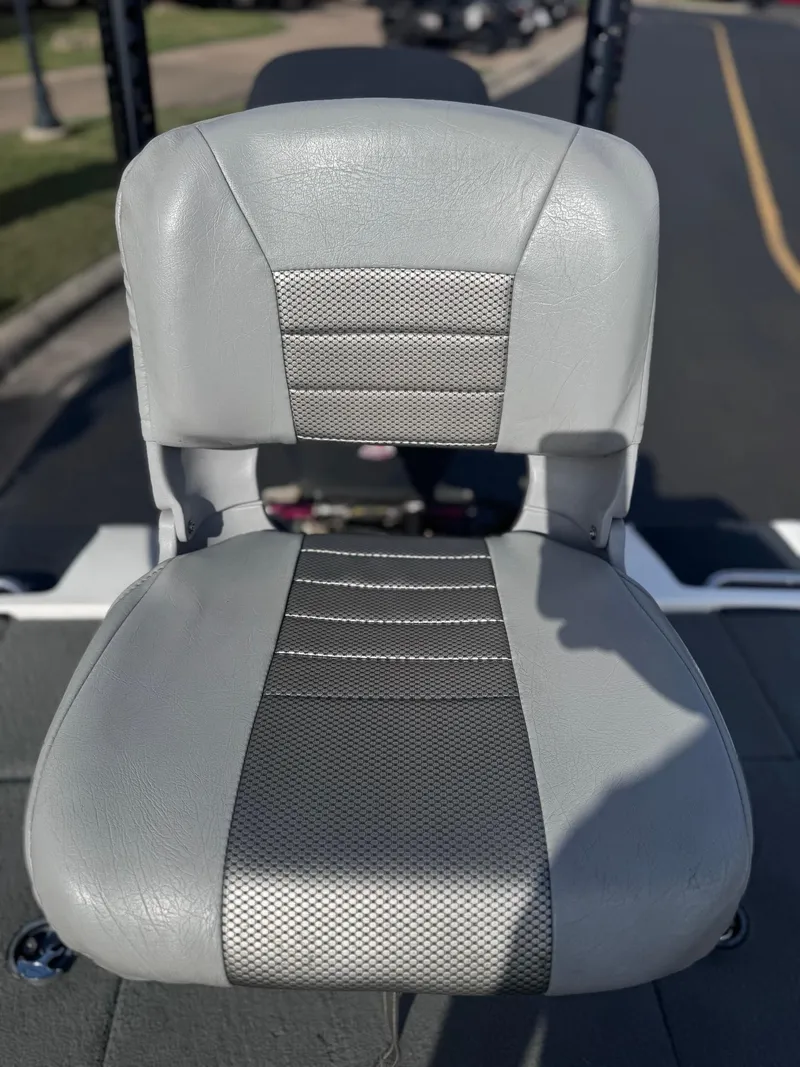 Slide: The Image of Gray seat of a 2007 Triton Tr-20X HP DC boat, featuring textured upholstery. - 11
