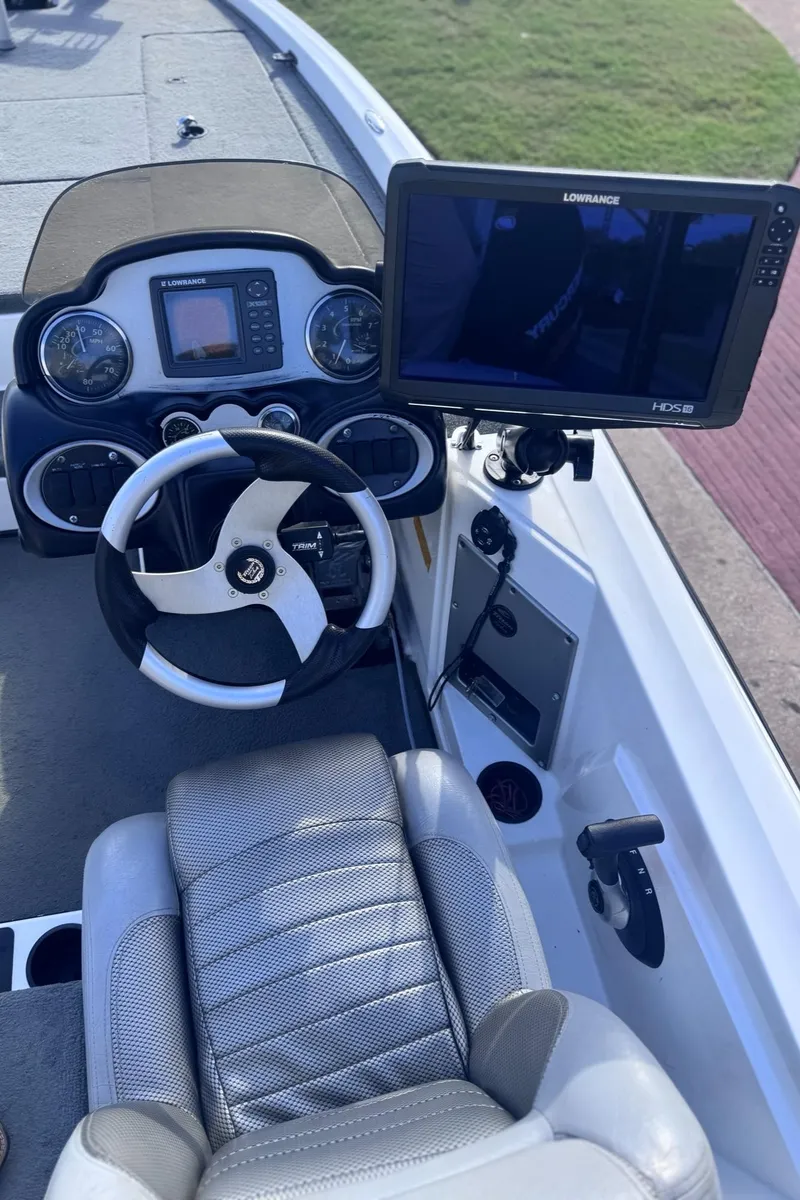 Slide: The Image of 2007 Triton Tr-20X HP DC boat cockpit with steering wheel and Lowrance HDS display. - 7