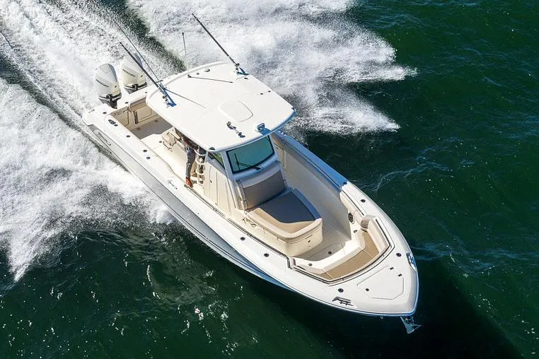 Slide: The Image of Manufacturer Provided Image: 2025 Boston Whaler 330 Outrage cruising on open water, aerial view. - 5