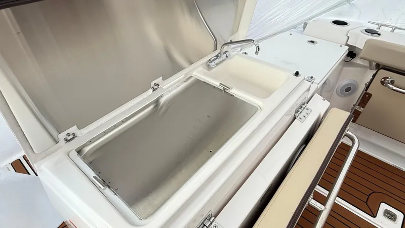 Slide: The Image of 2026 Ranger Tugs R-27 boat interior with sink and storage compartment. - 14