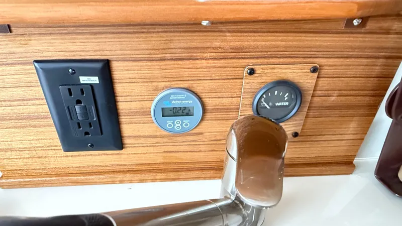 Slide: The Image of Control panel of 2026 Ranger Tugs R-27 with outlet, gauge, and faucet. - 34