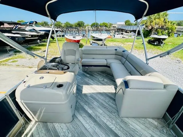 Slide: The Image of 2018 South Bay 525CPTR pontoon boat with spacious seating and canopy in a marina setting. - 13