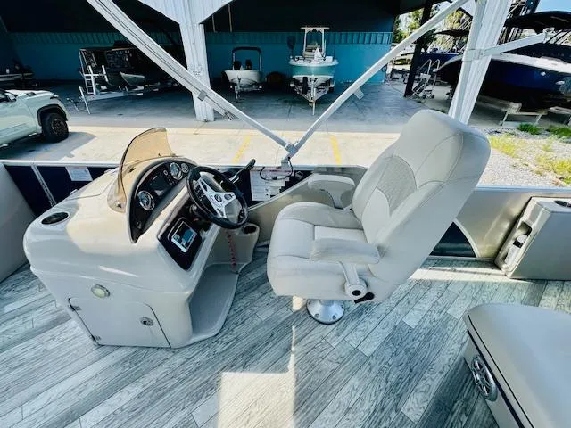 Slide: The Image of 2018 South Bay 525CPTR boat interior with captain's chair and control panel. - 16
