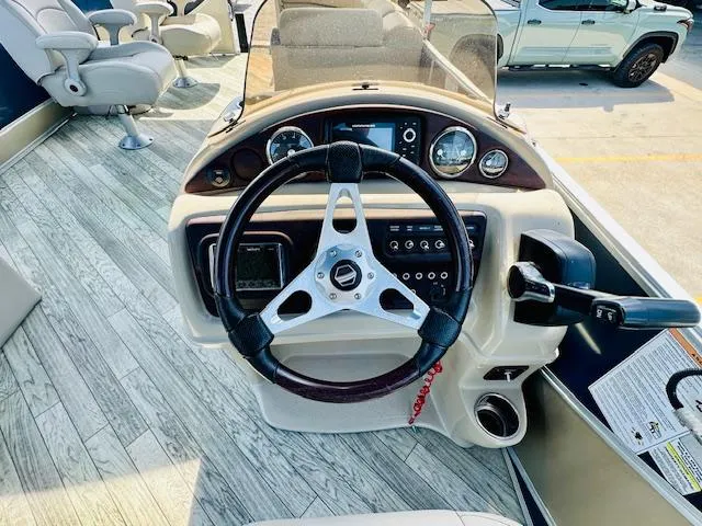 Slide: The Image of 2018 South Bay 525CPTR boat dashboard with steering wheel and controls. - 17
