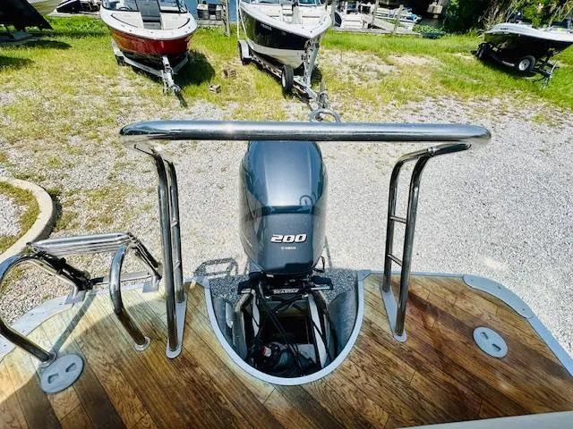 Slide: The Image of 2018 South Bay 525CPTR boat with Yamaha 200 engine, parked on gravel. - 20