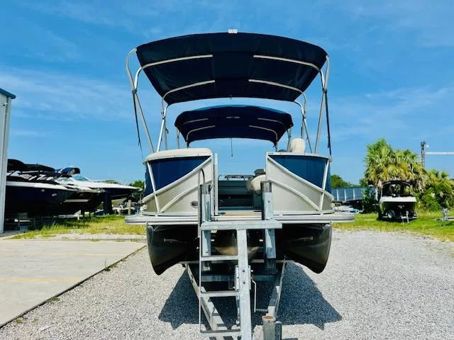 Slide: The Image of 2018 South Bay 525CPTR pontoon boat on trailer, blue canopy, sunny day. - 7