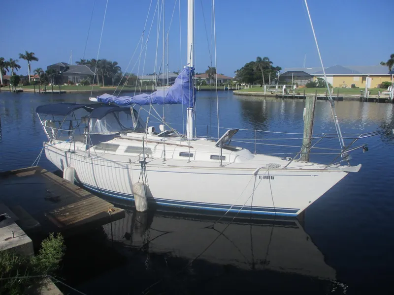 The Image of 1989 Sabre 30 MKIII sailboat docked in a serene marina setting. - 1