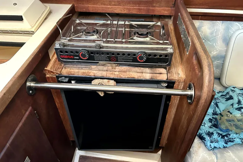 Slide: The Image of Compact kitchen area in a 1989 Sabre 30 MKIII sailboat with stove and storage. - 12