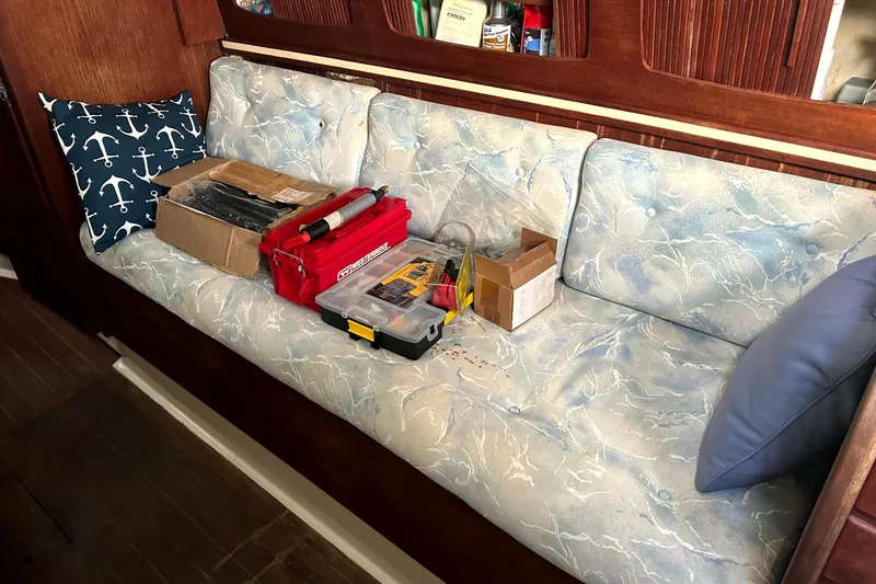 Slide: The Image of Cushioned seating with tools on a 1989 Sabre 30 MKIII sailboat interior. - 14