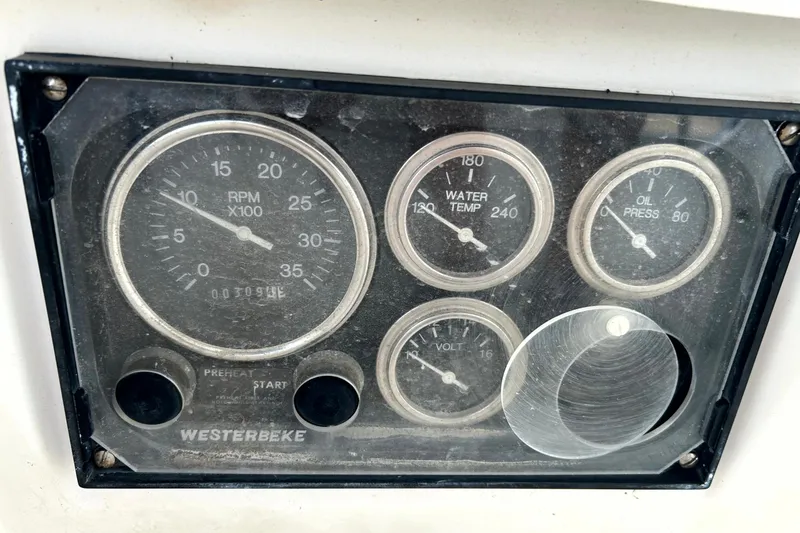 Slide: The Image of Dashboard gauges of a 1989 Sabre 30 MKIII sailboat, featuring RPM, water temp, oil pressure, and voltage. - 6
