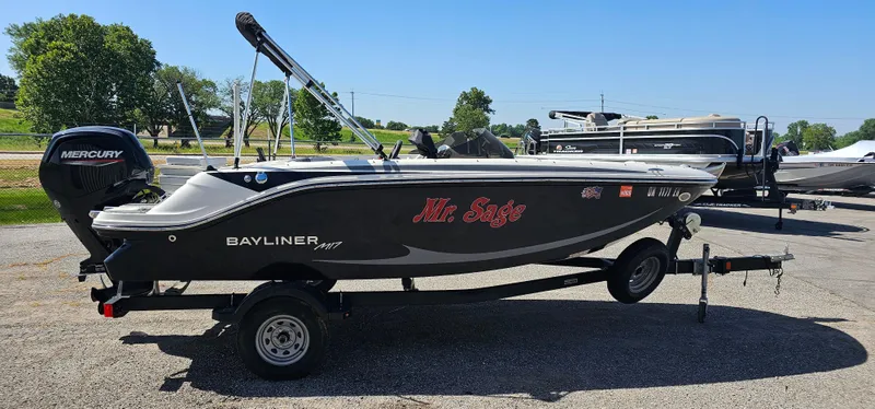 Slide: The Image of 2024 Bayliner Element M17 boat on trailer, featuring "Mr. Sage" text and Mercury engine. - 2