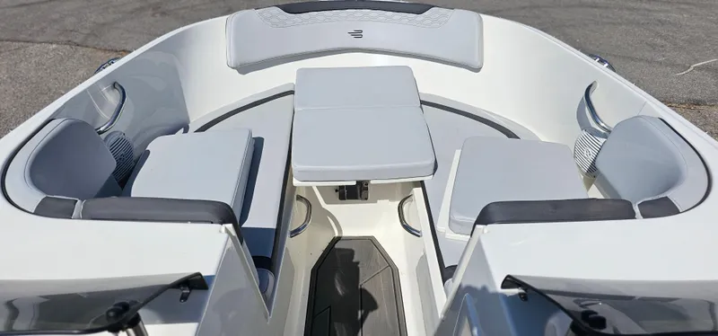 Slide: The Image of 2024 Bayliner Element M17 boat interior with gray seating and table, showcasing modern design. - 5