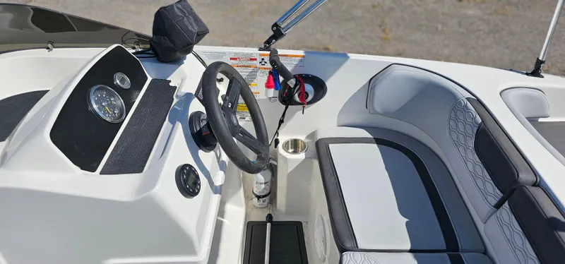 Slide: The Image of 2024 Bayliner Element M17 boat interior with steering wheel and seating area. - 9
