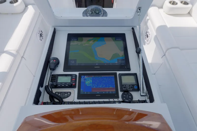 Slide: The Image of Control panel of a 1998 Gamefisherman Enticer boat with navigation and communication equipment. - 12