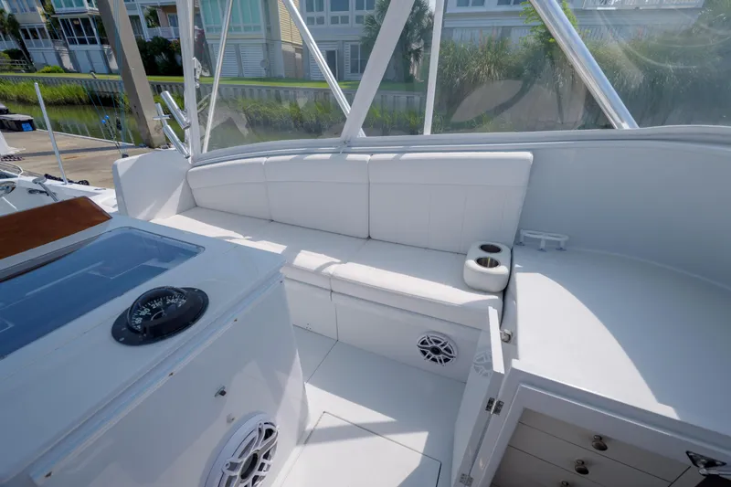 Slide: The Image of 1998 Gamefisherman Enticer boat interior with white seating, cup holders, and compass. - 15