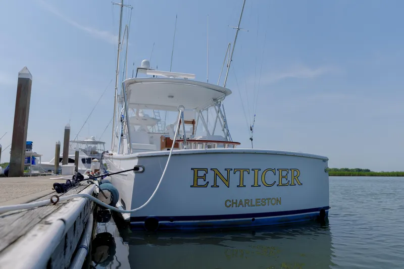 Slide: The Image of 1998 Gamefisherman Enticer boat docked in Charleston marina under clear blue sky. - 2