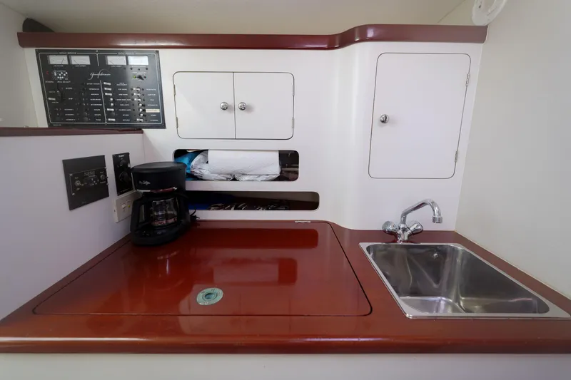 Slide: The Image of 1998 Gamefisherman Enticer yacht galley with sink, coffee maker, and control panel. - 20