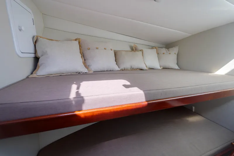 Slide: The Image of Cozy cabin interior of 1998 Gamefisherman Enticer with cushions and wooden trim. - 23