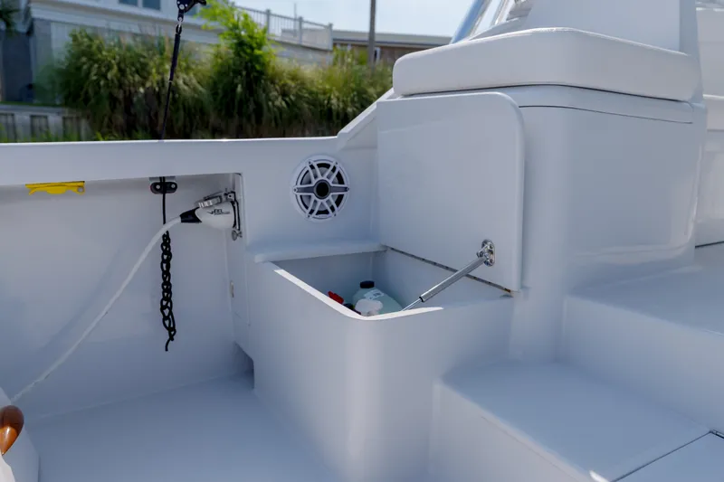 Slide: The Image of 1998 Gamefisherman Enticer boat interior with storage compartment and speaker. - 28