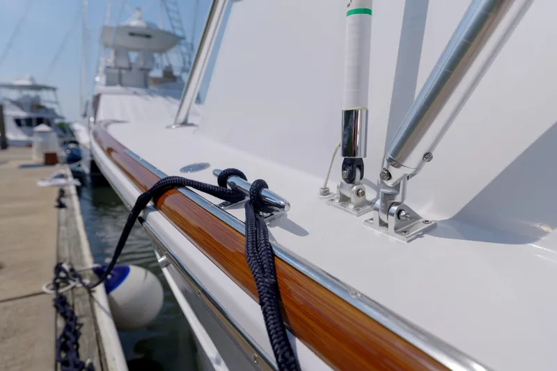 Slide: The Image of Close-up of 1998 Gamefisherman Enticer boat docked, showcasing polished wood and metal details. - 33