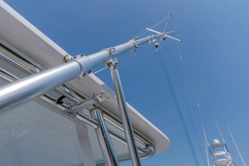 Slide: The Image of Close-up of Gamefisherman Enticer 1998 boat's metal rigging against clear blue sky. - 34