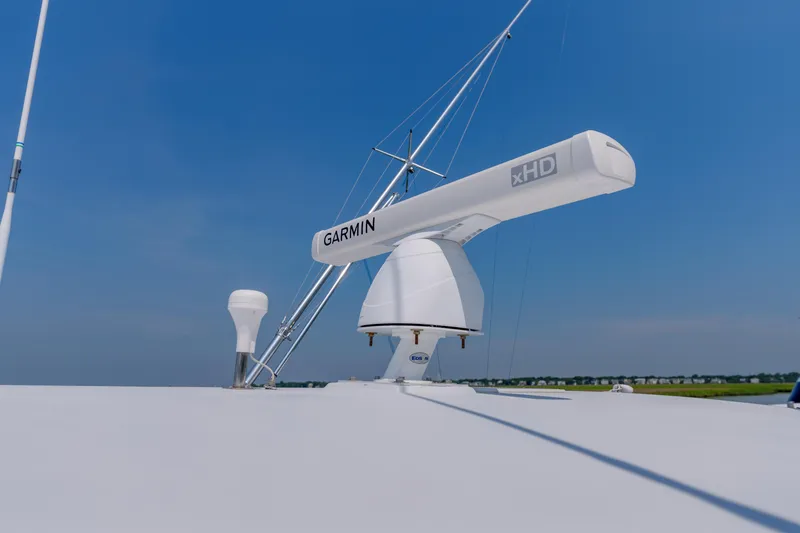 Slide: The Image of Radar equipment on 1998 Gamefisherman Enticer boat under clear blue sky. - 35