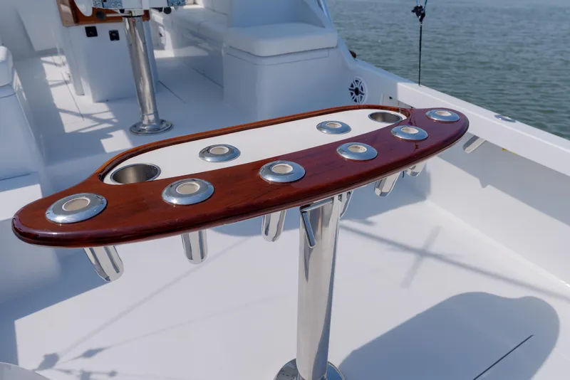 Slide: The Image of Fishing rod holders on a 1998 Gamefisherman Enticer boat deck, with ocean in the background. - 41