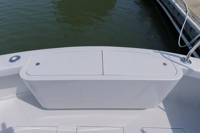 Slide: The Image of 1998 Gamefisherman Enticer boat deck, featuring a clean, white surface near the water. - 42