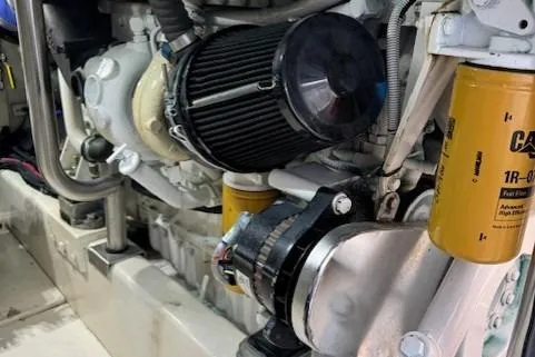 Slide: The Image of Engine components of a 1998 Gamefisherman 34 Express boat, featuring filters and mechanical parts. - 46