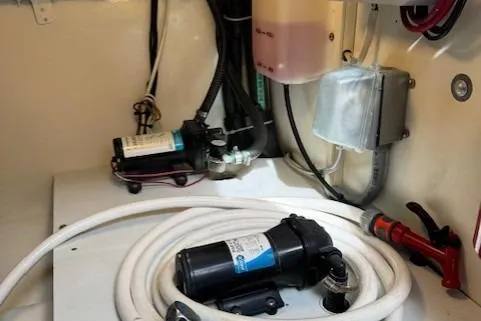 Slide: The Image of 1998 Gamefisherman 34 Express engine room with pumps and wiring. - 47