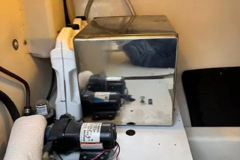 Slide: The Image of 1998 Gamefisherman 34 Express engine room with equipment and reflective surfaces. - 48