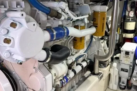 Slide: The Image of Engine room of 1998 Gamefisherman 34 Express with visible pipes and filters. - 49