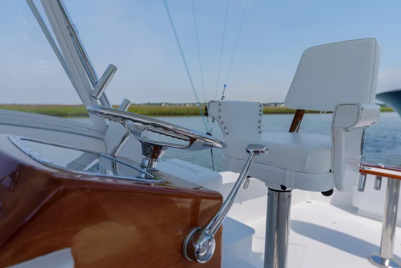 Slide: The Image of 1998 Gamefisherman Enticer helm with steering wheel and captain's chair on a sunny day. - 5