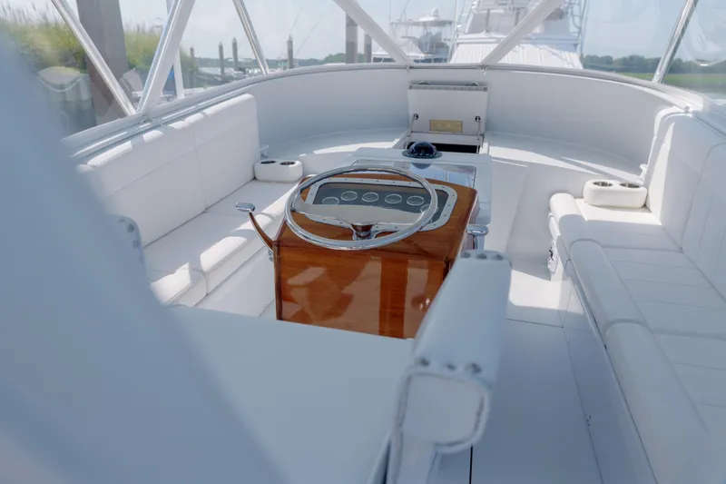 Slide: The Image of Luxurious 1998 Gamefisherman Enticer boat interior with white seating and polished wood helm. - 8