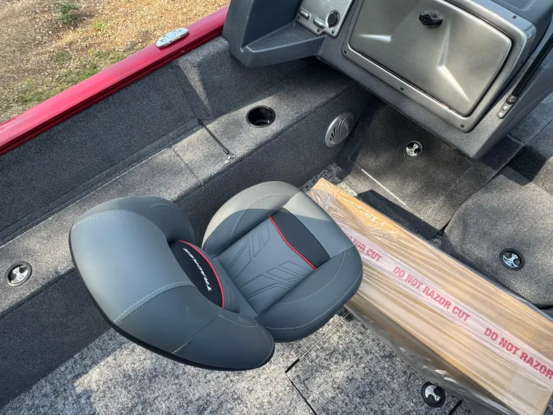 Slide: The Image of 2025 Tracker Pro Guide V-175 Combo boat interior with gray seat and storage compartment. - 10