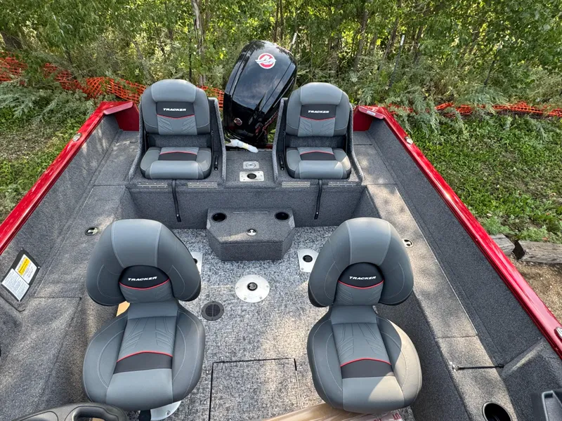Slide: The Image of 2025 Tracker Pro Guide V-175 Combo boat interior with four gray seats and red accents. - 15